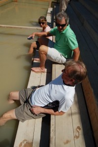 A group of tourists is conducting baptisms on the Israeli side. I (foreground) and a couple of fellow travelers cool off in the muddy river. 